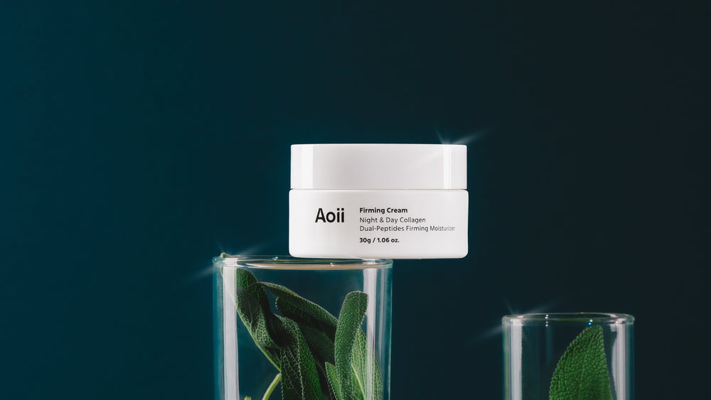 AOii Firming Cream jar with green leaves in the background